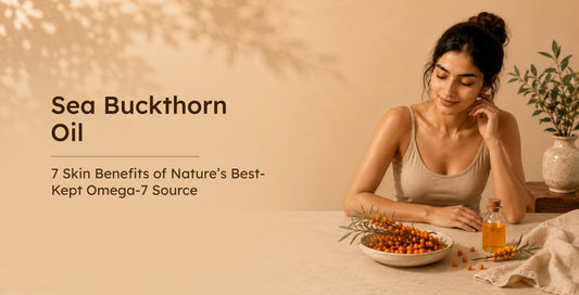 A woman looking at a bowl of fresh sea buckthorn berries and a bottle of oil on a warm, neutral table.